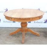 20th century circular hardwood breakfast table, on turned baluster support and four shaped legs,