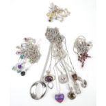 Collection of silver jewellery, mostly pendants and chains all in silver, with a set of earrings,