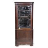 20th century mahogany floor standing corner cabinet with astragal glazed door over cupboard,