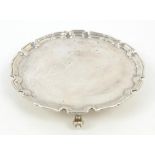 Silver salver with scalloped edge on three scroll feet, Edward Barnard & Sons Ltd, London 1940,