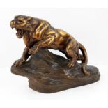 Armand Fagotto (19th/ 20th Century). A panther on a rock, patinated and gilt terracotta,