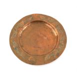 Arts and crafts beaten copper dish with a stylised foliate design to the rim, 19cm diameter