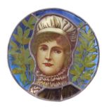 Leaded stained glass roundel, painted with a woman in a bonnet in front of leaves and branches,