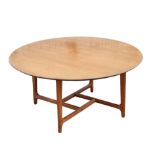 Danish teak circular topped coffee table, on tapering legs joined by stretchers, with label to