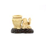 A Japanese Okimono , Meiji Period Carved Ivory representing a  man with a pot . Wood stand  8.