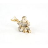 A Japanese Okimono , Meiji Period Circa 1880 Carved Ivory representing a boy man playing with a toy