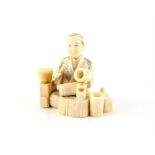 A Japanese Okimono , Meiji Period Circa 1880 Carved Ivory representing a sitting man working with