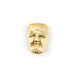 A Japanese Netsuke , Meiji Period Carved Ivory representing a mask  , . 3.3X 2.2 cm,