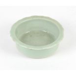 A Japanese Celadon Brush Washer , Edo period with a steeply sided barbed rim , the base unglazed,