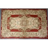 Aubusson rug, with central floral medallion and scrolling foliage and floral garlands on a pink