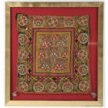 Indian textile panel with embroidered with stylised flowers predominately in pinks and yellows 34cm