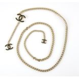 Chanel jewellery belt, a gold tone chain link belt, with two 'CC' monograms hanging, length 100 cm