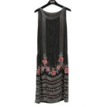 1920s black georgette beaded and sequinned evening dress with stylized floral motifs in pink and