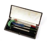 Cased set of four sterling silver bridge pencils in blue, green, red and black