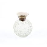 Hinged top silver bulbous scent bottle with cut glass body and original internal stopper by Jones,