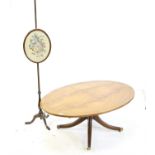 Mahogany oval topped coffee table on quartefoil base and brass caps and castors, H50 W122 D84.