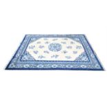 Chinese carpet with central floral medallion and floral motifs on a cream ground within floral and