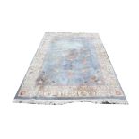 Chinese wool pile carpet, with central floral medallion and floral motifs on a light blue ground