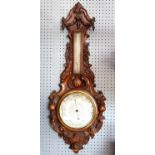 Victorian carved walnut aneroid banjo barometer, with thermometer, the frame carved with fruit,