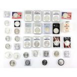 A collection of 55 American silver eagle coins of various dates, mostly in capsules but including a