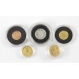 Four small gold coins and one small platinum coin, all cased, comprising gold Gibraltar quarter