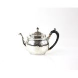 George III silver teapot with acorn finial, oval form with bright cut decoration, wooden handle,