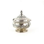 Edward VII silver repousse lidded jar, the hinged lid enclosing a gilded interior,