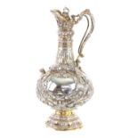 Victorian silver wine ewer cast in high relief on an orange peel ground, with winged figures,