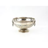 Victorian silver repousse twin handle bowl, with foliate scroll design and lion mask handles on a
