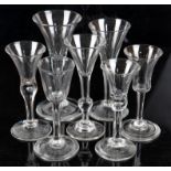 Seven 18th and 19th century drinking glasses, four with bubbled stems, all on round feet,