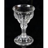 19th century drinking glass with faceted bowl, bubbled stem on stepped round foot, 17cm high,