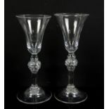 Pair of 18th century drinking glasses with bubbled knopped stems on round feet, 18.5cm high,