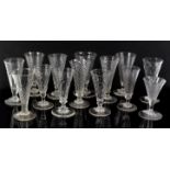 Fourteen 18th/19th century non-matching drinking glasses with spiral form bowls, each approximately