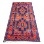 Caucasian Derbend rug, with three medallions on a blue ground within stylised floral borders,