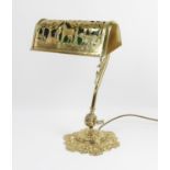 Early 20th century brass desk lamp, the green glass and brass shade depicting hounds gathering the