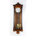 19th century walnut and ebonised Vienna style wall clock, shaped moulded cornice over a glazed door,