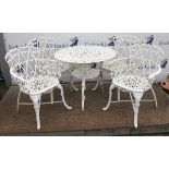 Set of four cast iron garden armchairs and a circular table, all with pierced scrolling heart shape