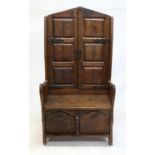 French oak cupboard and bench, the panelled back forming two cupboard doors enclosing galleried