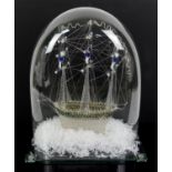Late 19th century glass model frigger of a ship with sailors in the rigging, under glass dome,