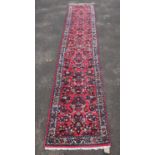 Persian Sarouk runner, repeating floral motifs on a pink ground within cream ground floral border,