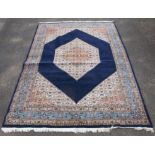 Persian Khorasan carpet, with central medallion and floral motifs on a dark blue ground,