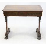 Regency rosewood side table, the brass inlaid top over a frieze drawer on carved end supports with
