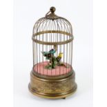 Reuge singing birdcage automaton, the two singing birds, in yellow and blue amongst leaves,