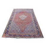 Persian Bidjar carpet, central medallion and geometric and floral motifs on a terracotta ground,