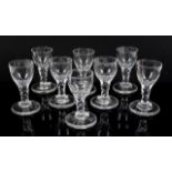 18th/19th century near matching set of eight drinking glasses with faceted stems on heavy round