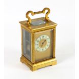 Brass and four glass carriage clock with lever movement, the chapter ring with Arabic numerals,
