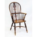 19th century ash and elm Windsor armchair, the high back with solid fret carved splat over a