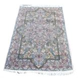 Srinagar part silk ground rug, with central floral medallion and blossoming flowers within a