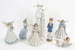 Three Lladro figures of angels, original boxes (nos. 5830, 5719 and 5831), a figure group of nuns