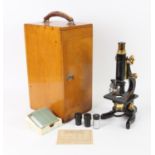 W. Watson & Sons lacquered steel and brass Microscope with triple lens turret, and two eyepieces,